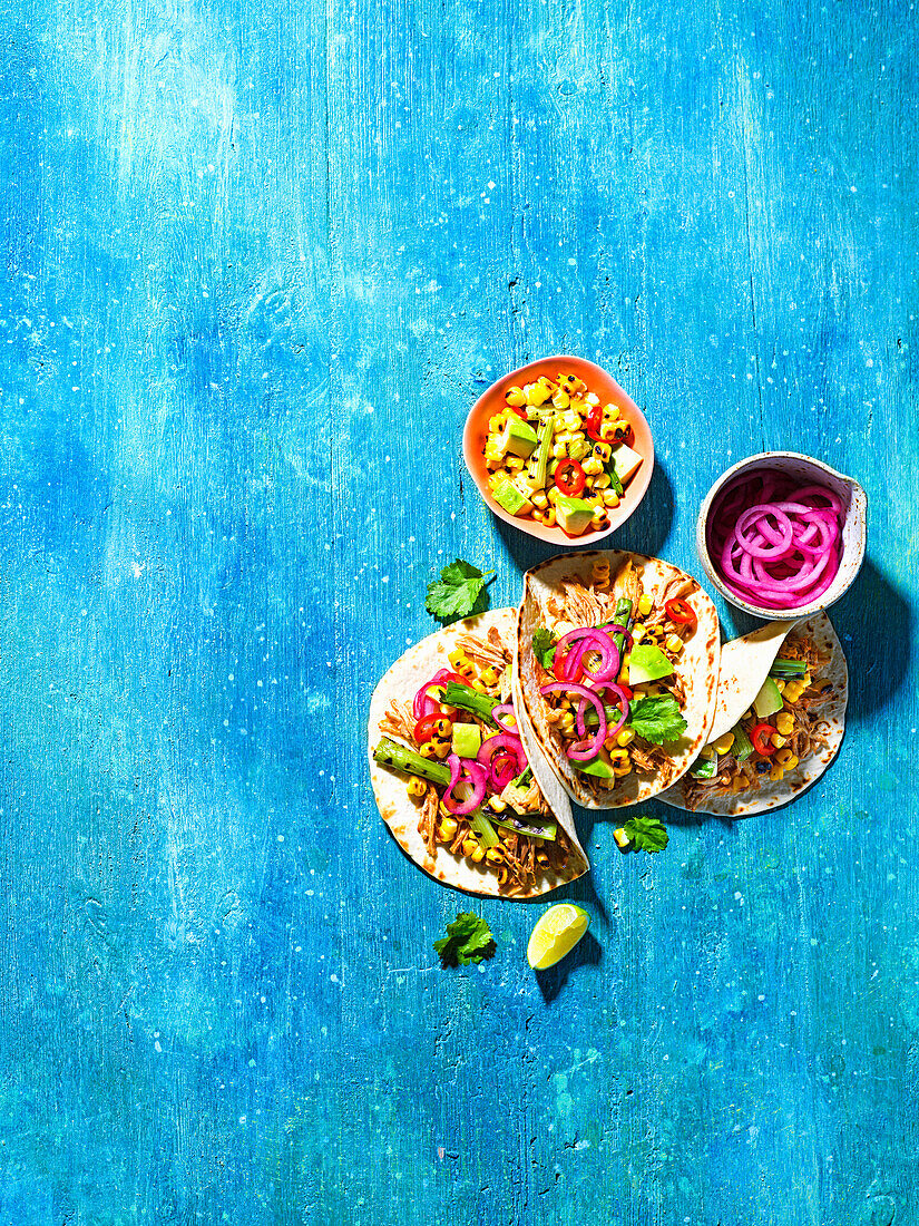 Pulled pork tacos with charred corn salsa and pickled onions