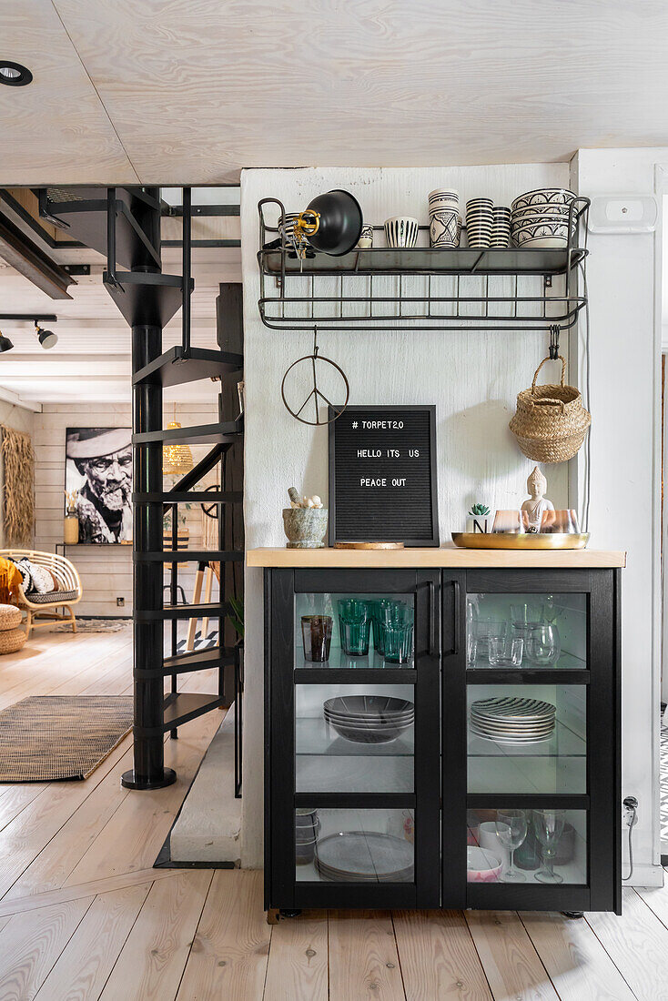 Display cabinet with crockery, above open shelf next to a passageway