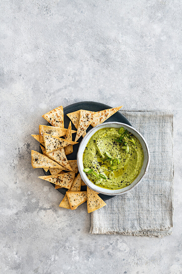Pea, spring onion and black lime hummus with pitta chips