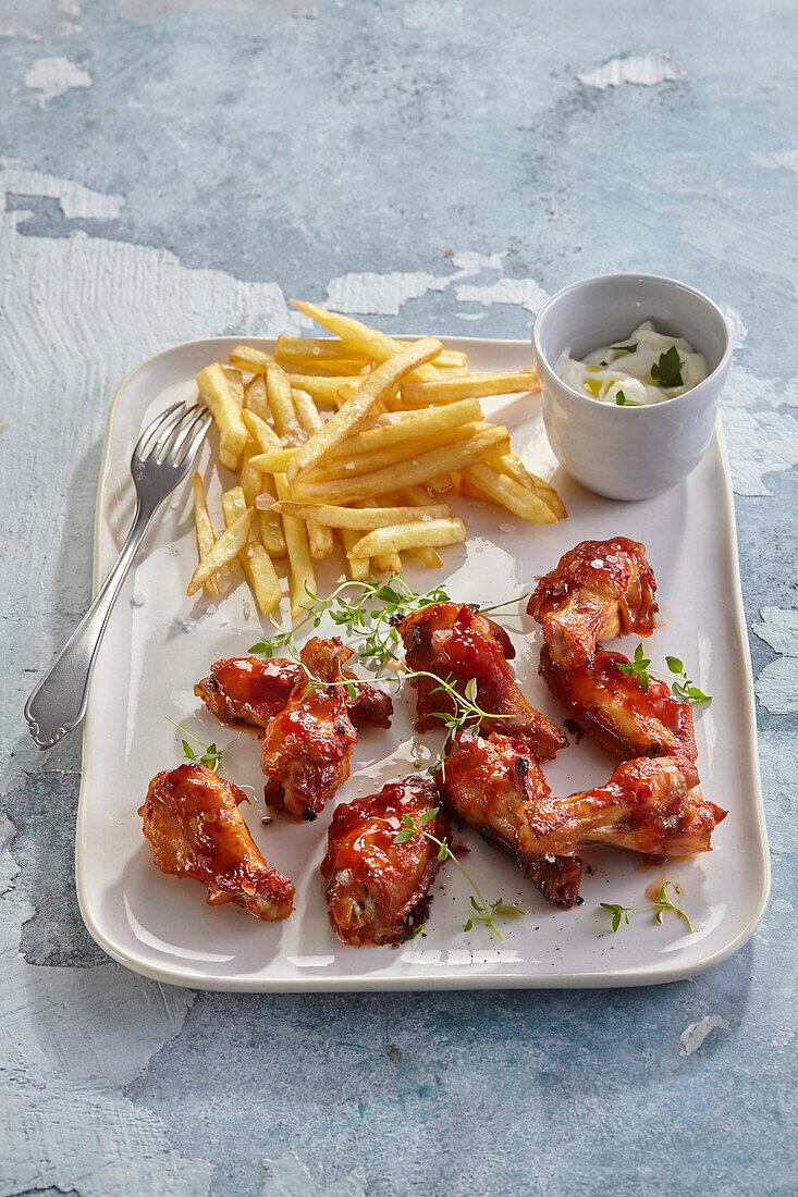 Spicy honey chicken wings served with french fries