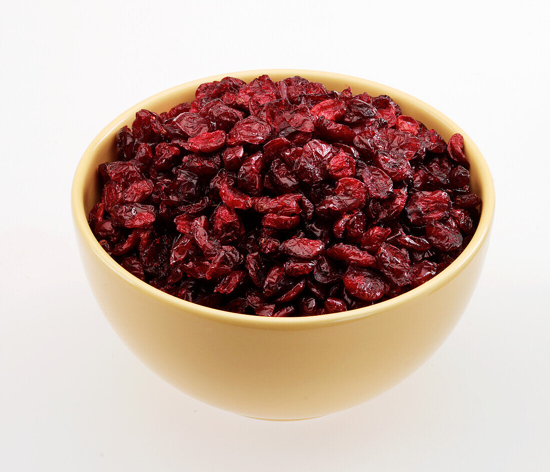 Dried cranberries in a yellow ceramic bowl