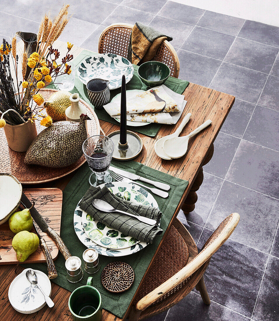 Set wooden table with green placemats