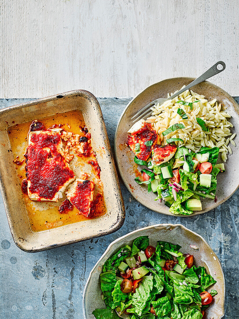 Baked feta with chilli chorizo jam served with orzo and leaf salad with avocado