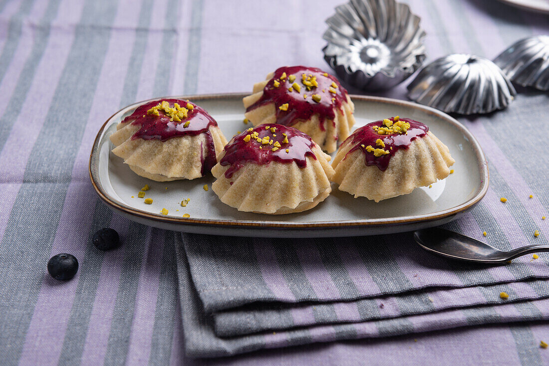 Vegan mini tartlets with blueberry soy yoghurt filling, and pistachios