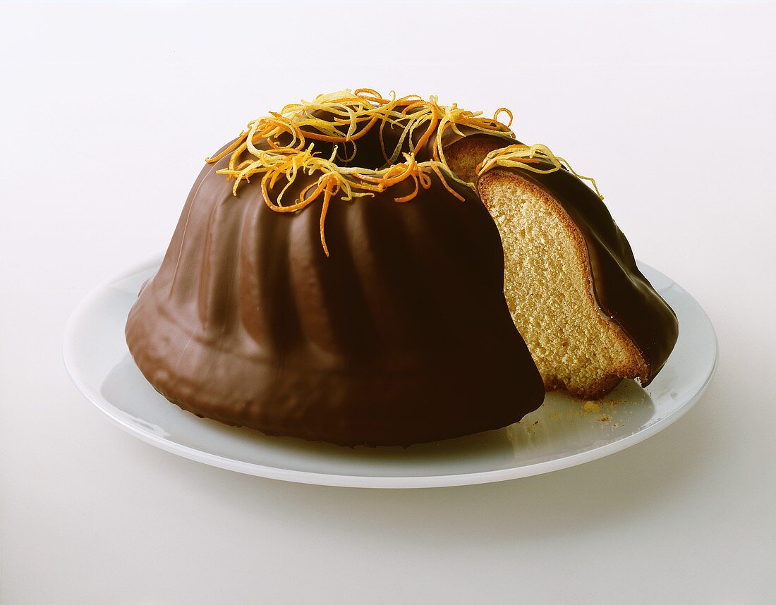 Fruit cake with chocolate icing, orange and lemon zest