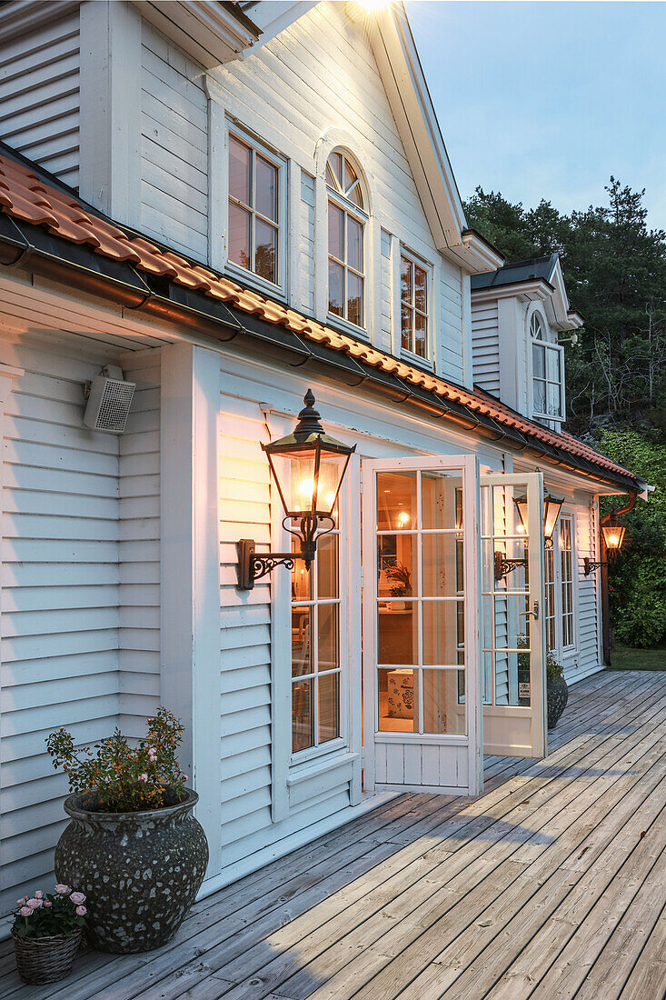 Scandinavian-style wooden house with lattice windows and lanterns