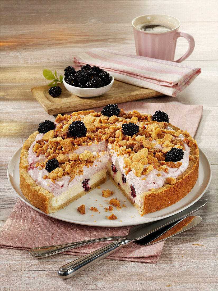 Double cream cheesecake with blackberries and a crumble topping