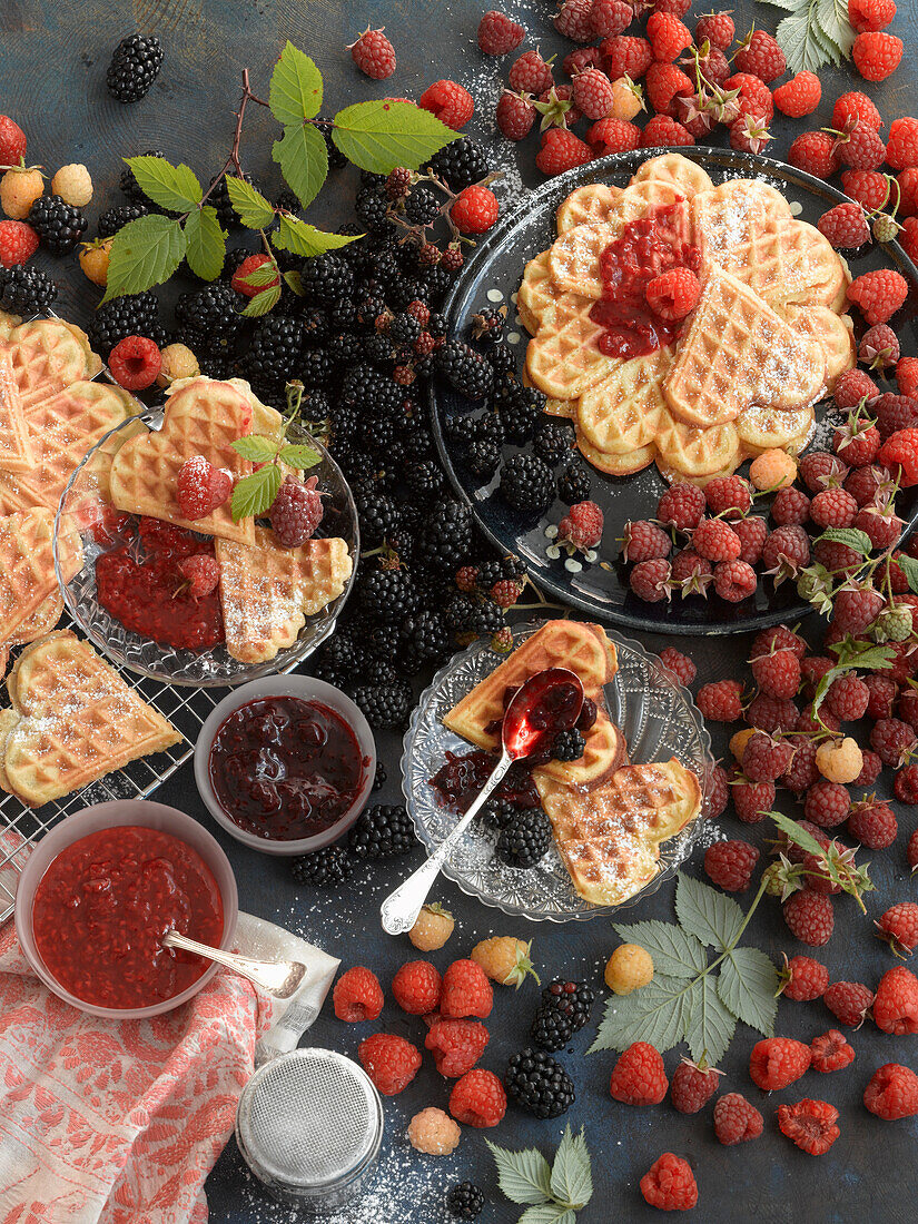 Waffles with fresh raspberries and blackberries, raspberry jam, and blackberry jam