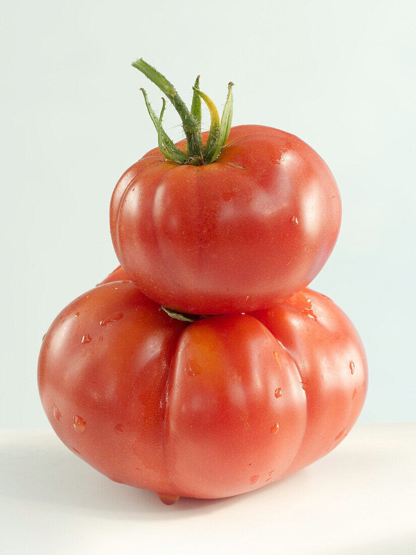 Two tomatoes stacked on top of each other