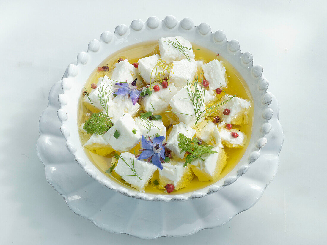Bowl with feta, olive oil, red pepper, and herbs