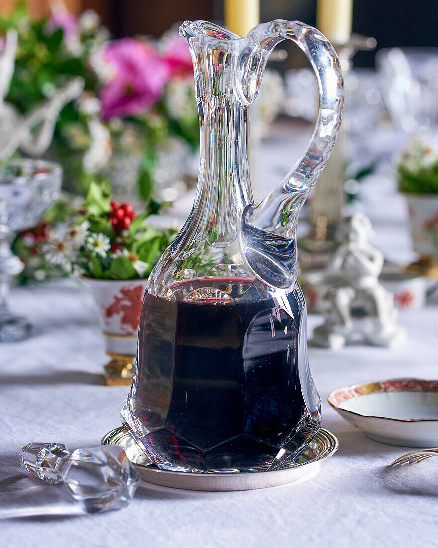 A carafe of red wine on a festively set table