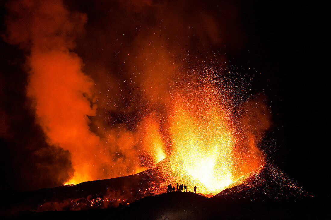 Tourists watching a volcano eruption, Iceland