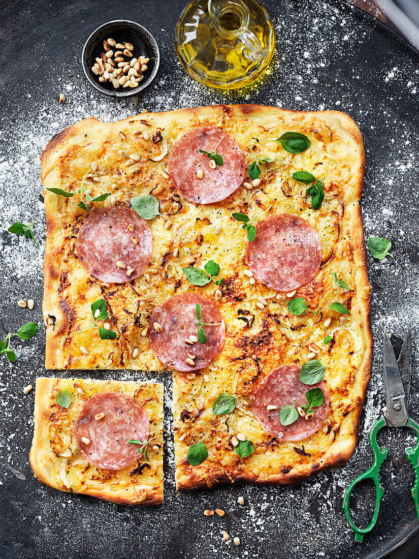 Pizza bianca with salami fennel, oregano and pine nuts