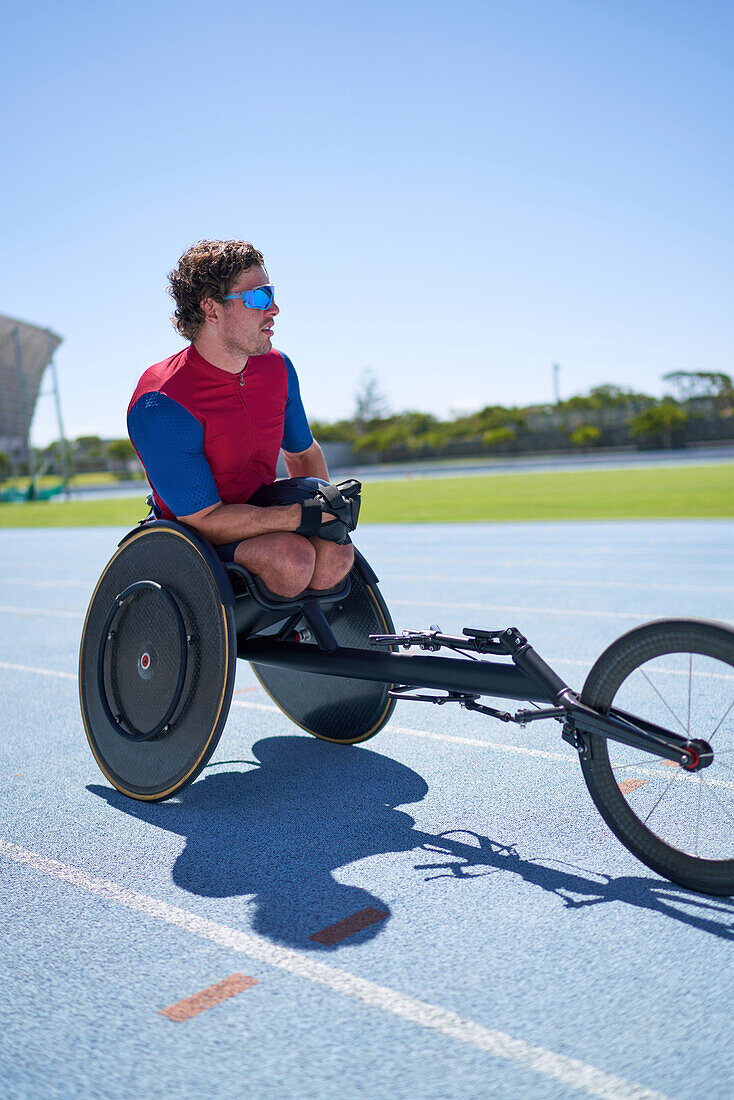 Wheelchair athlete on sunny sports track