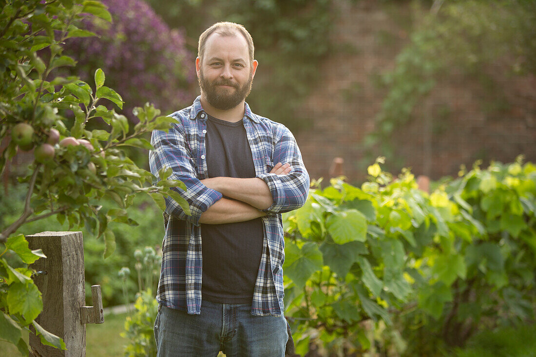 Confident man with beard in garden