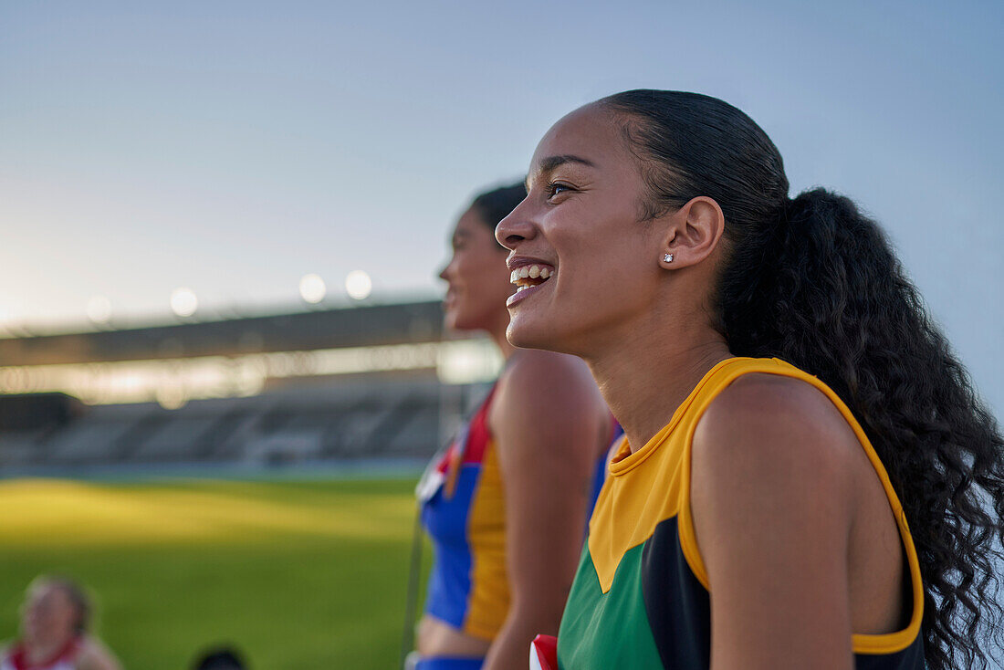 Happy female track and field athlete laughing