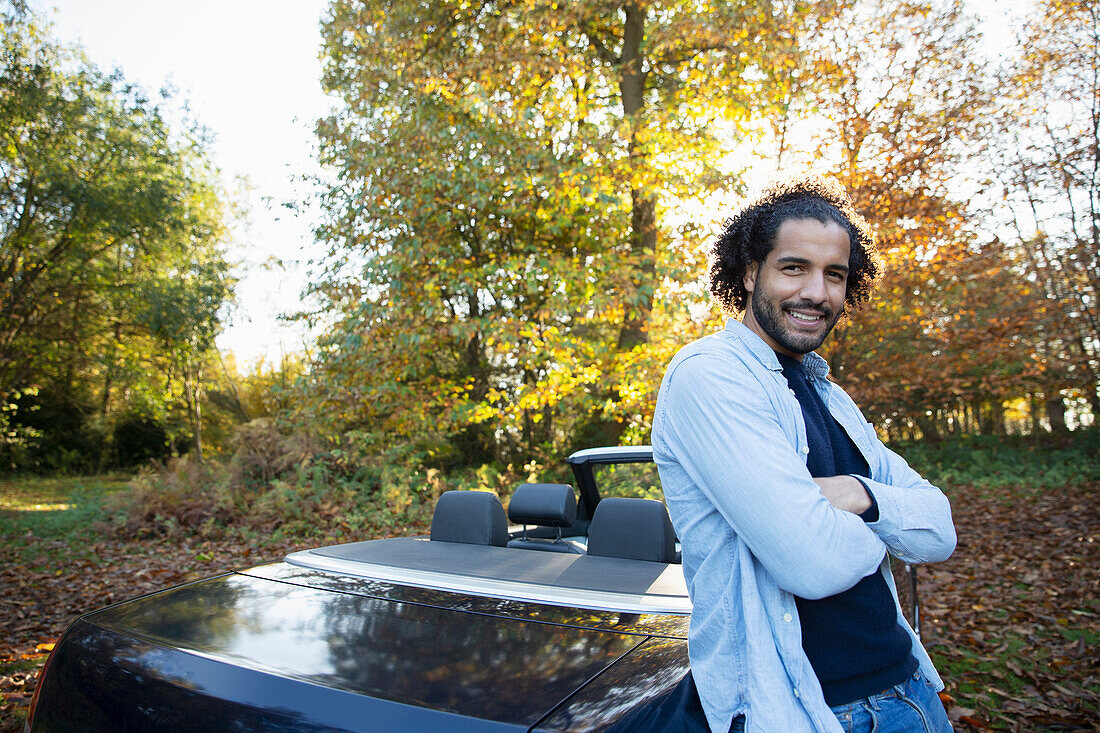 Happy man in convertible in autumn park