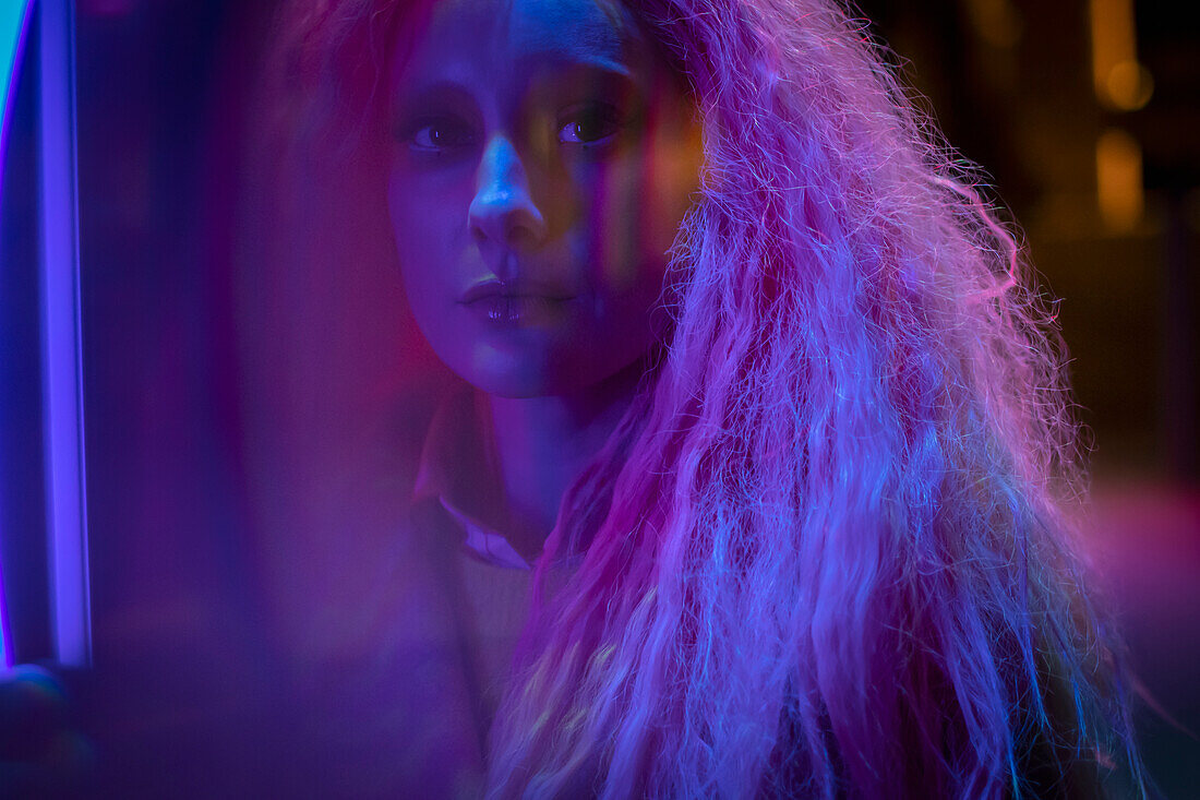 Woman with pink hair in neon light