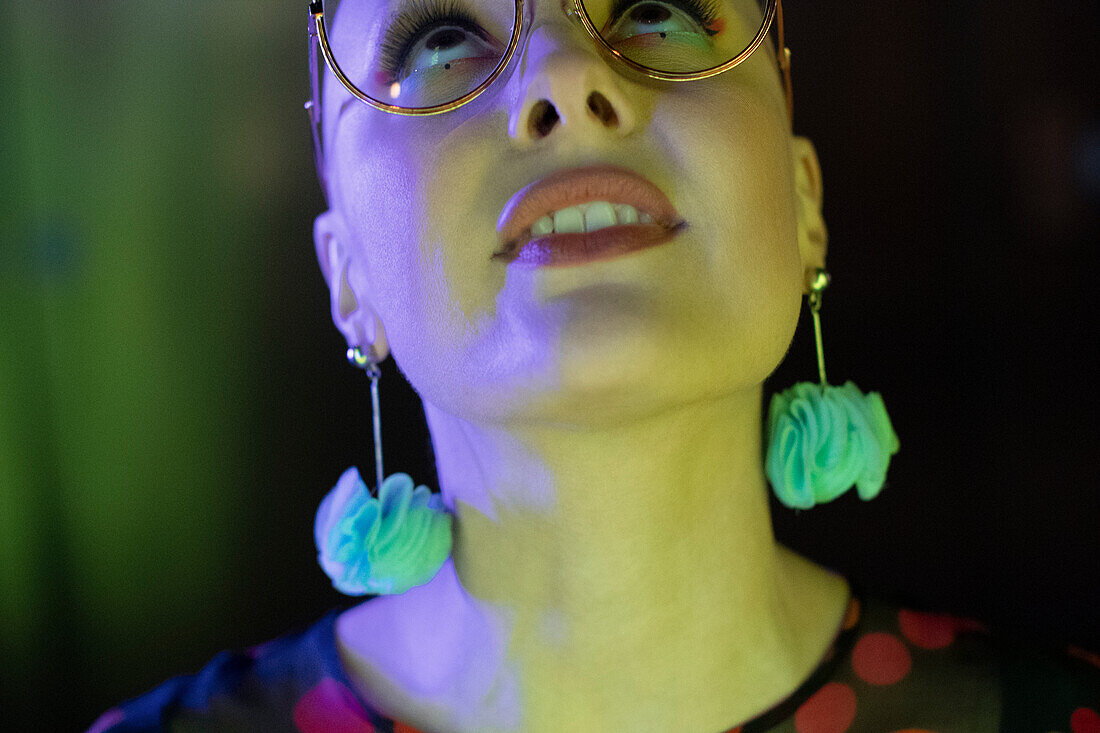 Woman in earrings looking up