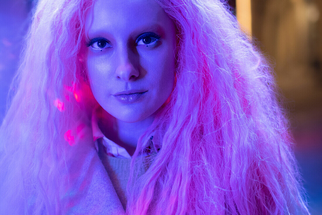 Woman with pink hair in neon light