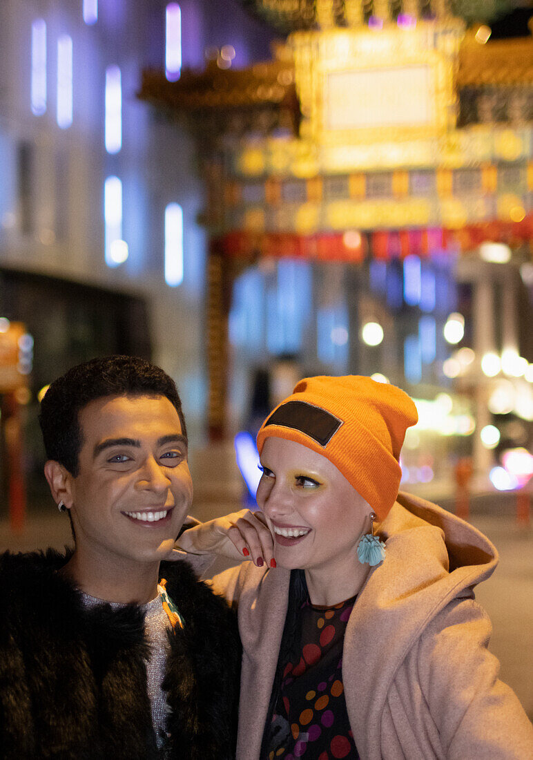 Happy couple at Chinatown Gate at night, London, UK