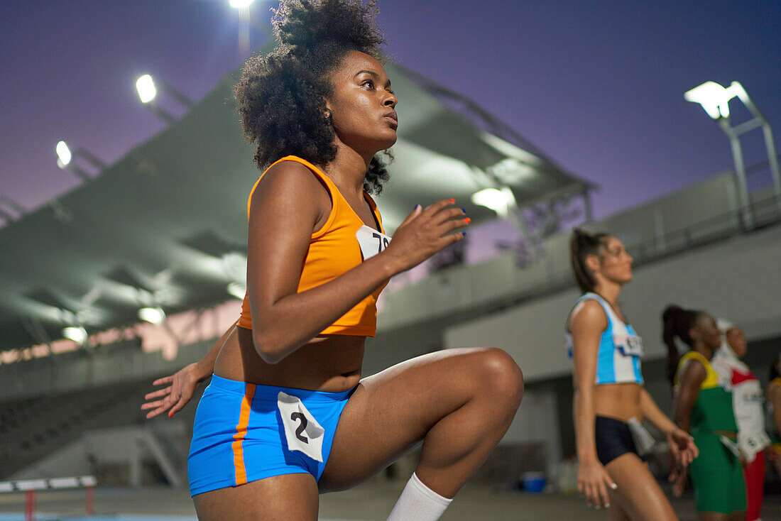 Focused athlete preparing for race in stadium