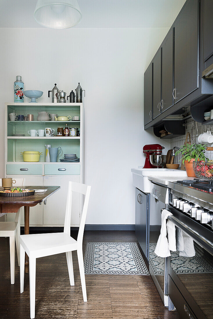 Fitted cupboards, table and 50s sideboard in the kitchen-dining room