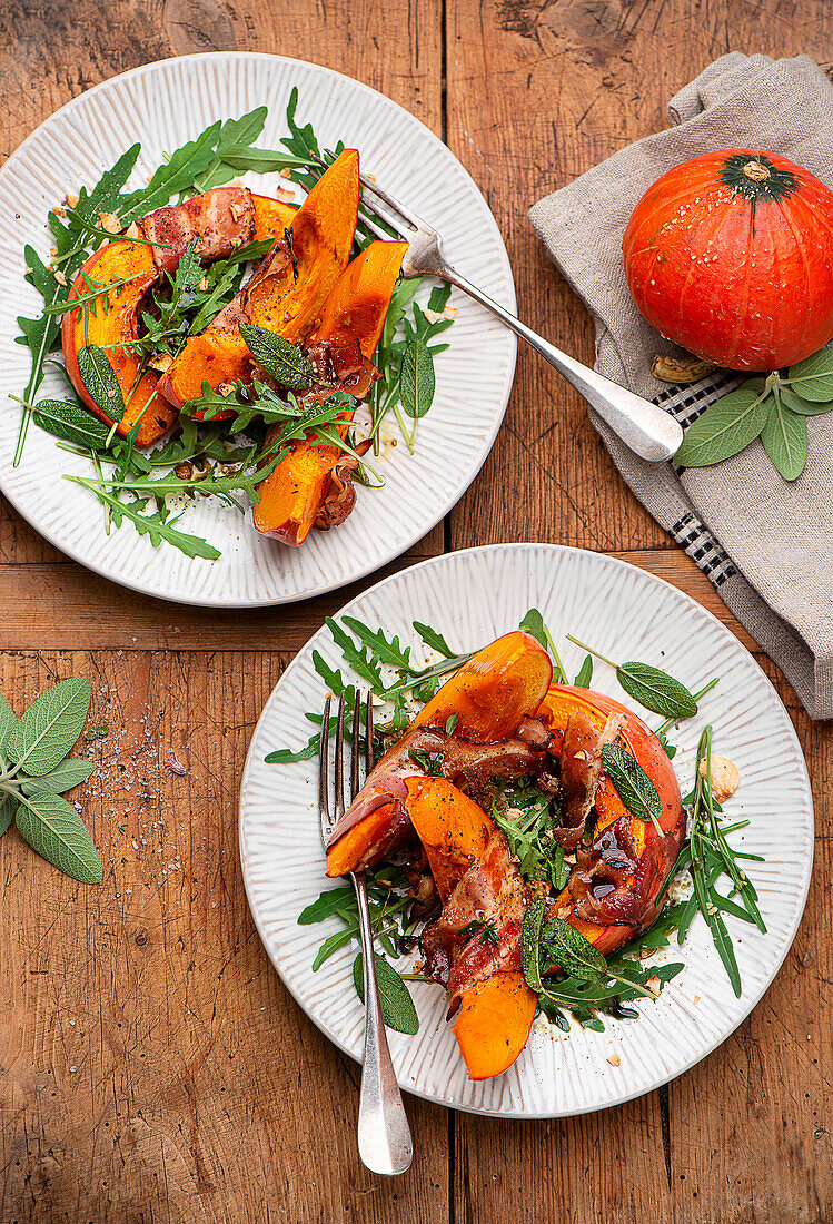 Bacon wrapped pumpkin slices served on arugula with sage leaves