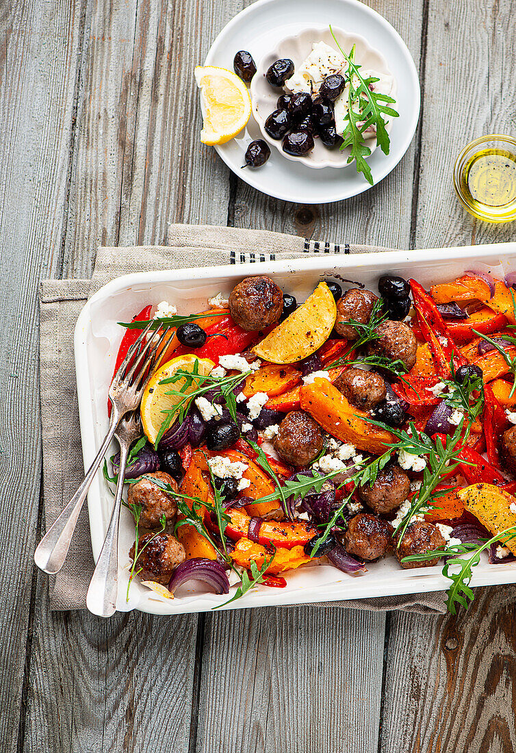 Meatballs on a tray with oven vegetables and pumpkin