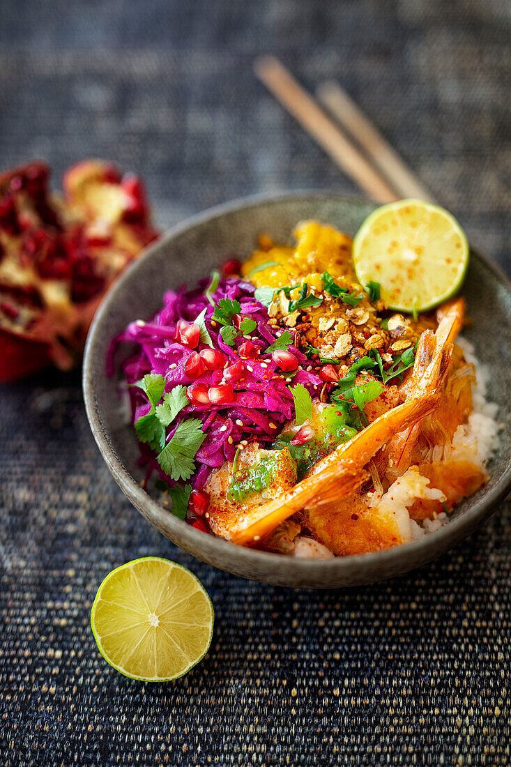 Poke bowl with red pointed cabbage salad, fried corn strips and prawns