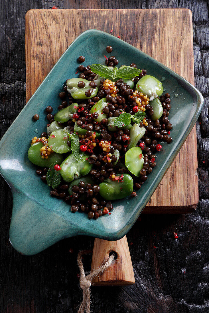 Black lentil and boiled broad beans salad with mint leaves