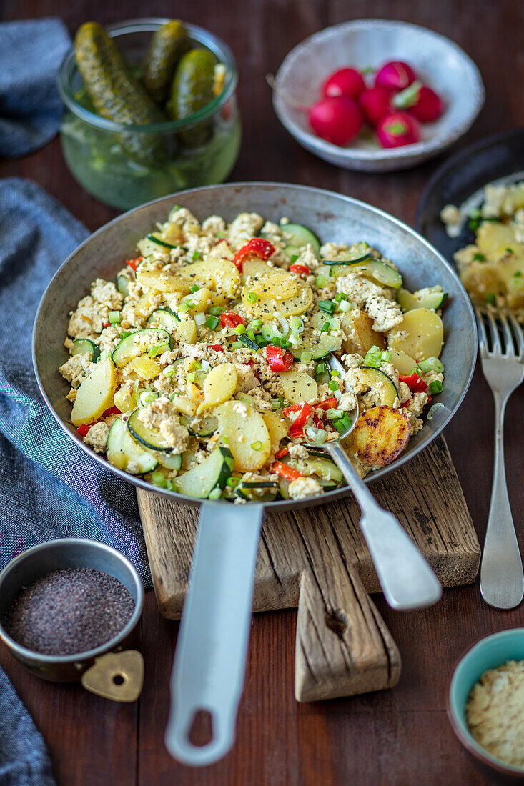 Vegan scrambled eggs made with tofu with potatoes and veggies