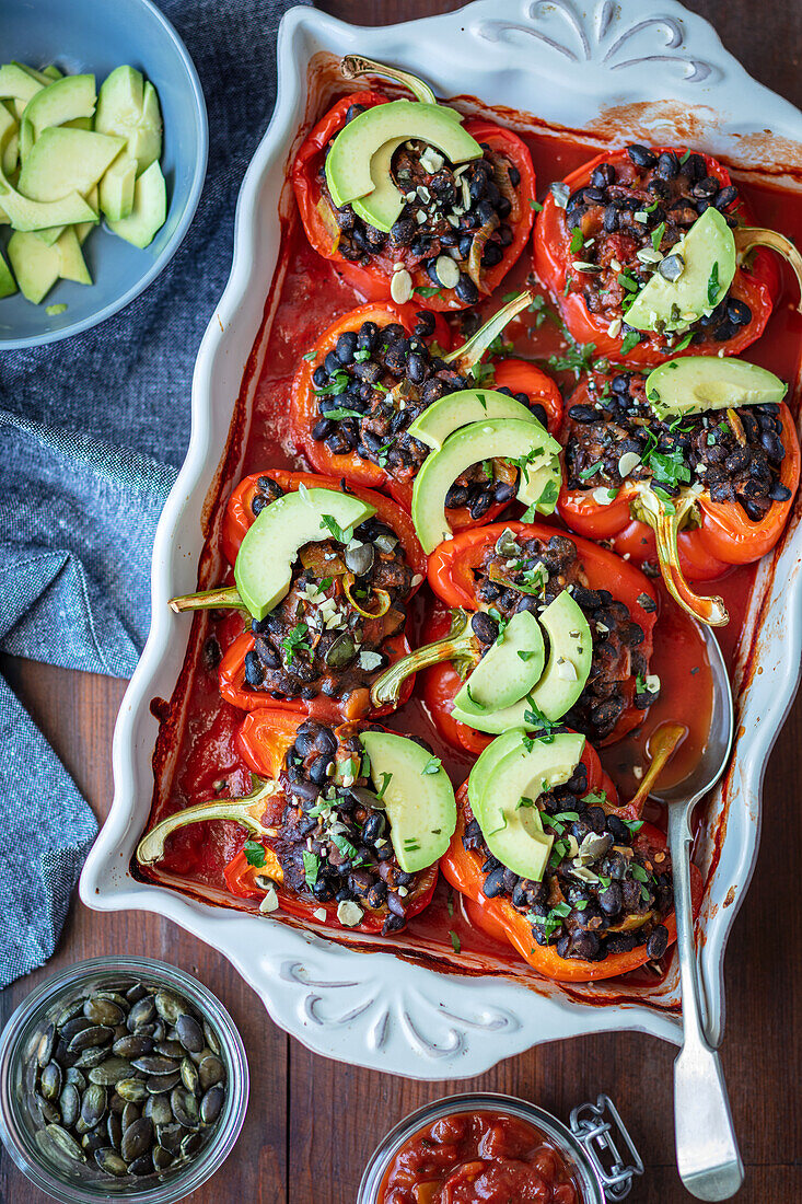 Red peppers stuffed with black beans and avocado