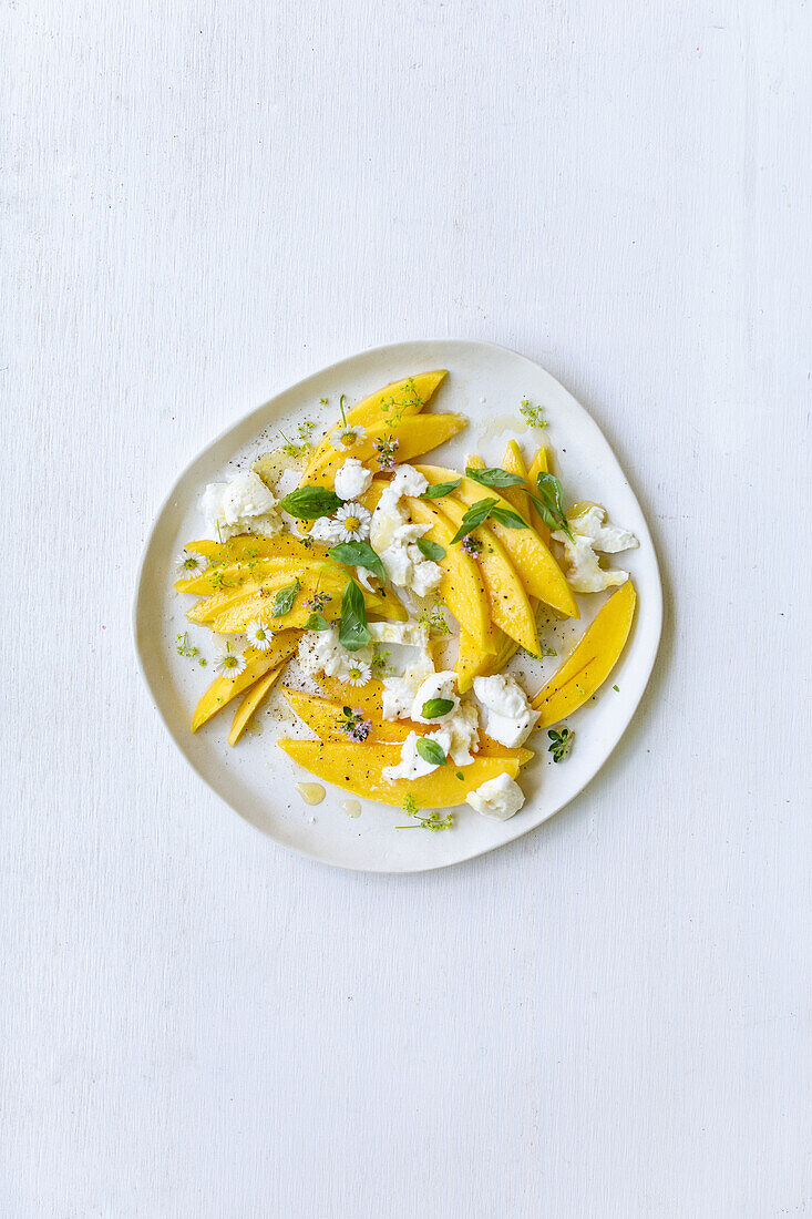 Mango-and-mozzarella salad with daisies