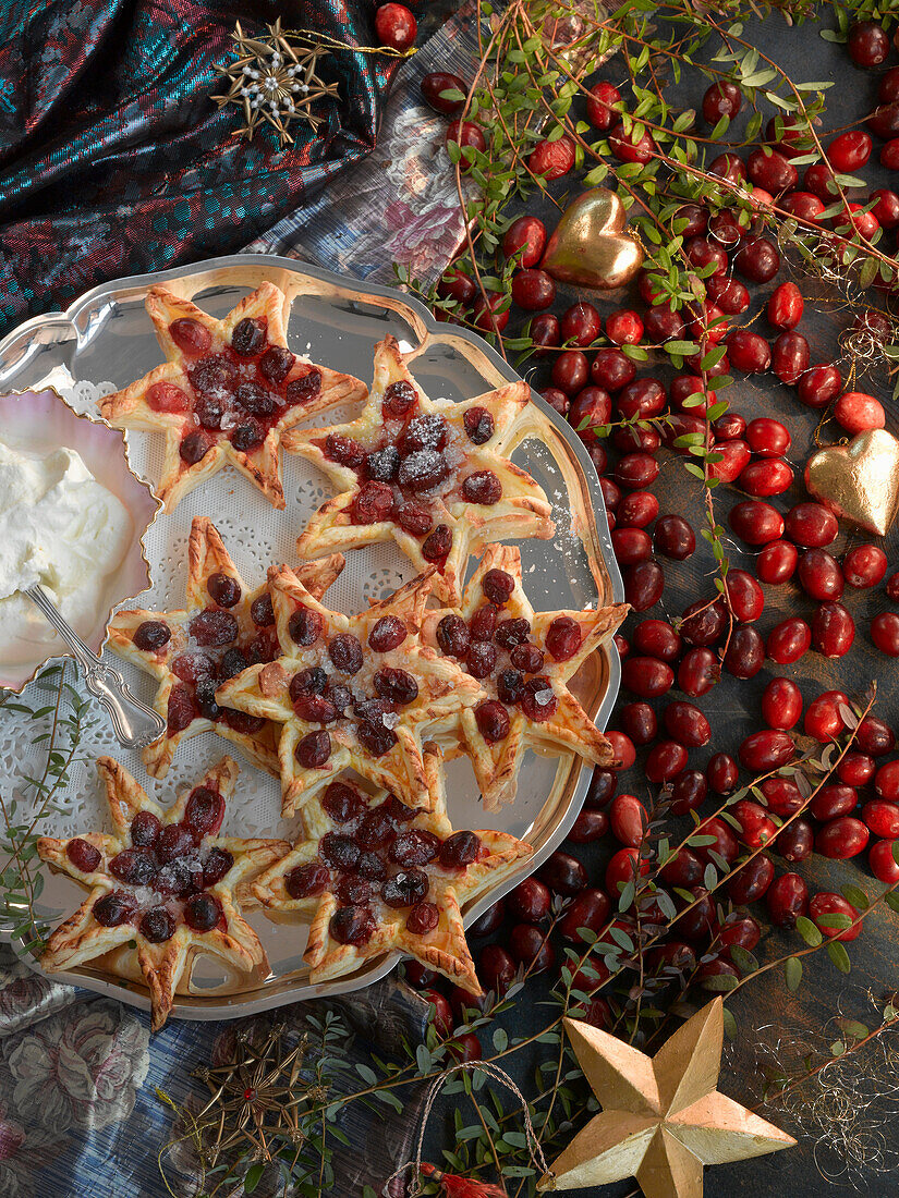 Puff pastry stars with cranberries and whipped cream for Christmas