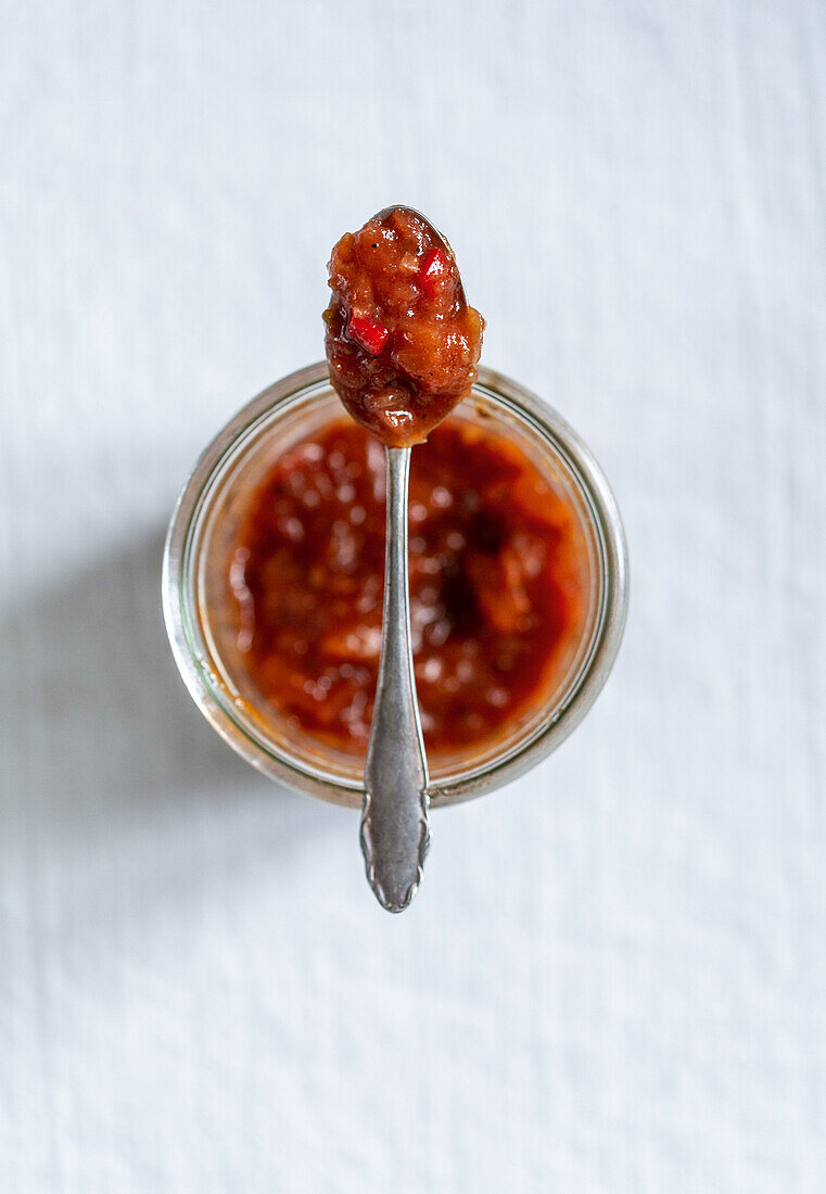 Tomaten-Chutney im Glas und auf Löffel
