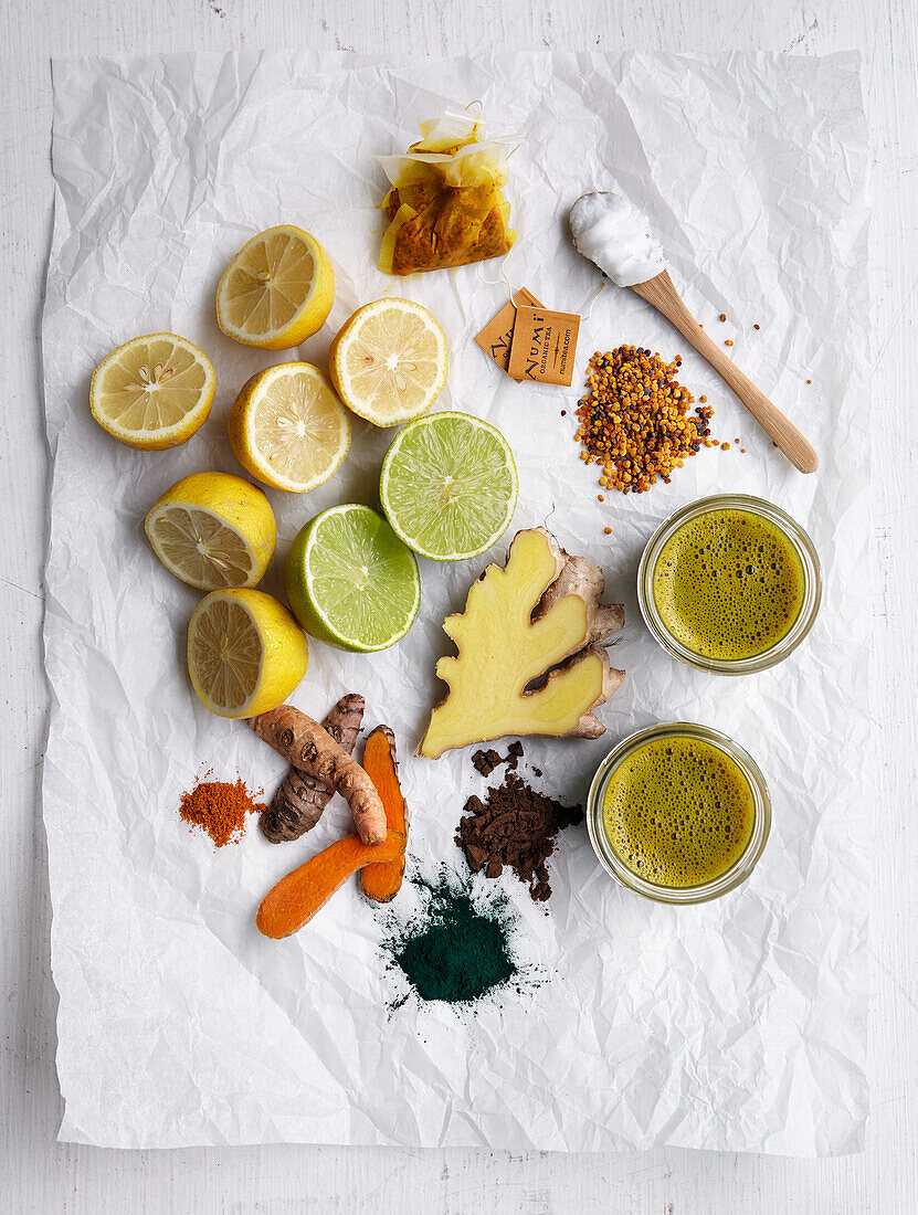 Ingredients for healthy shots - lemons, limes, ginger, tumeric, spirulina, bee pollen, coconut oil