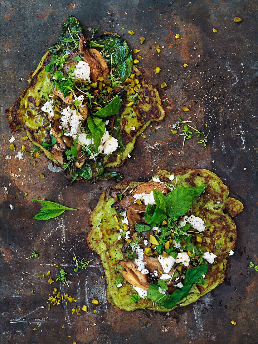 Green pea tortillas with mushrooms, cheese, pistachios, cress and mint