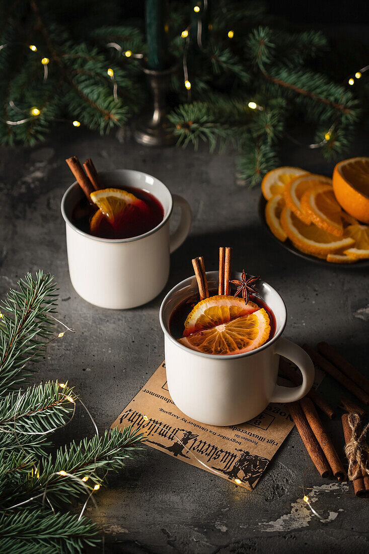 Mulled wine in mugs on concrete background