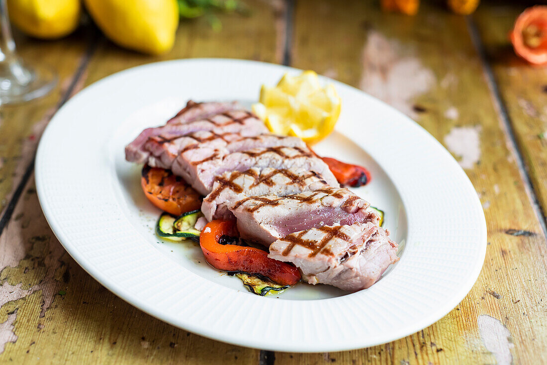 Grilled Sicilian tuna steak on a bed of vegetables