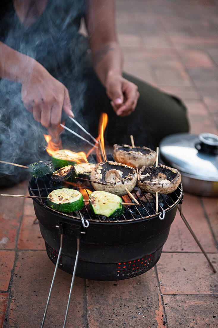 Woman hands barbequeing vegetables