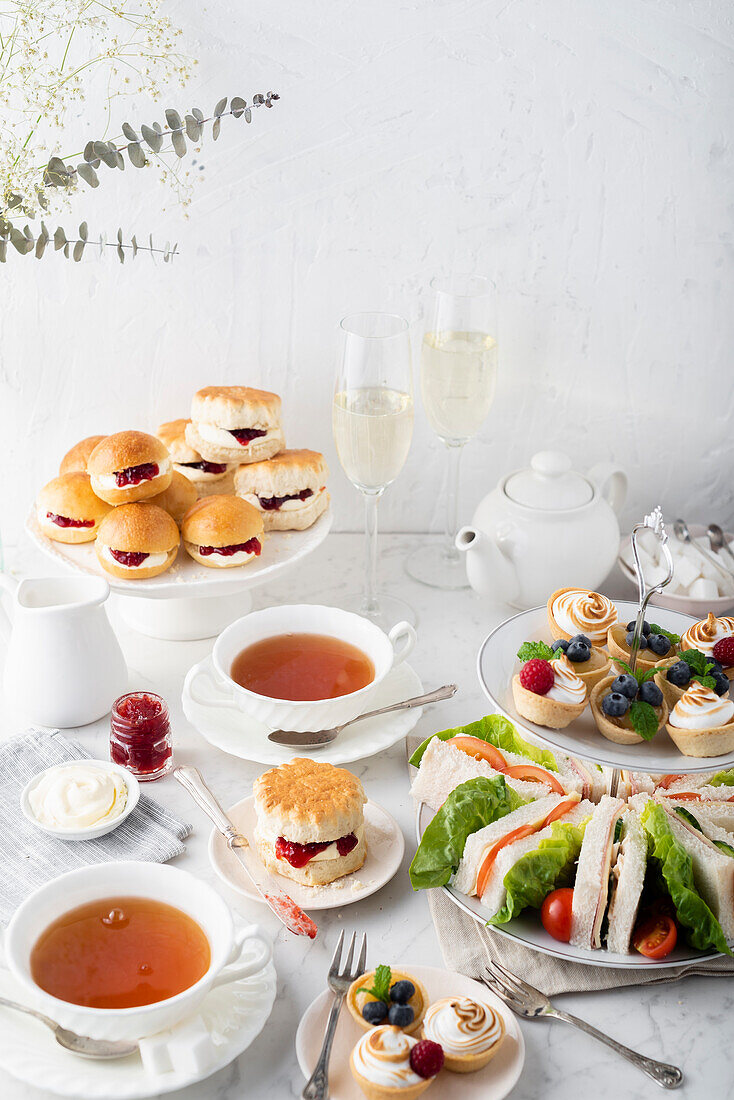 Afternoon tea scene with savoury and sweet treats