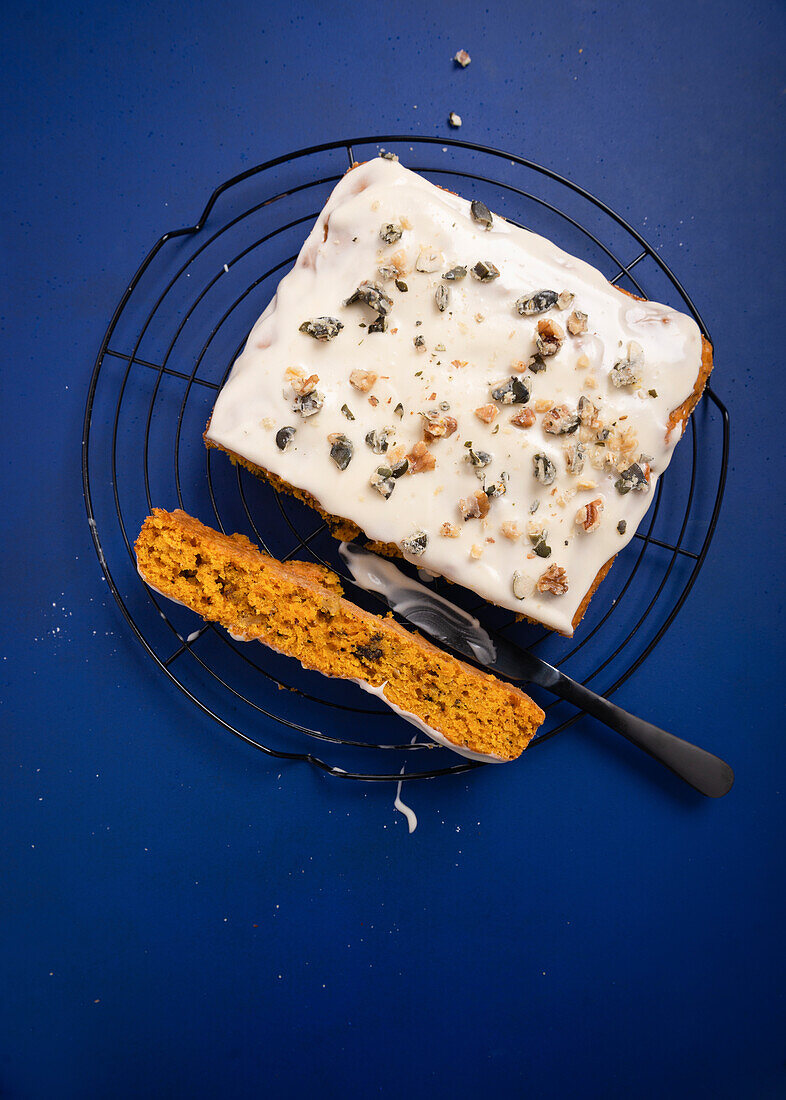 Pumpkin cake with vegan cream cheese topping, caramelised pumpkin and walnut seeds