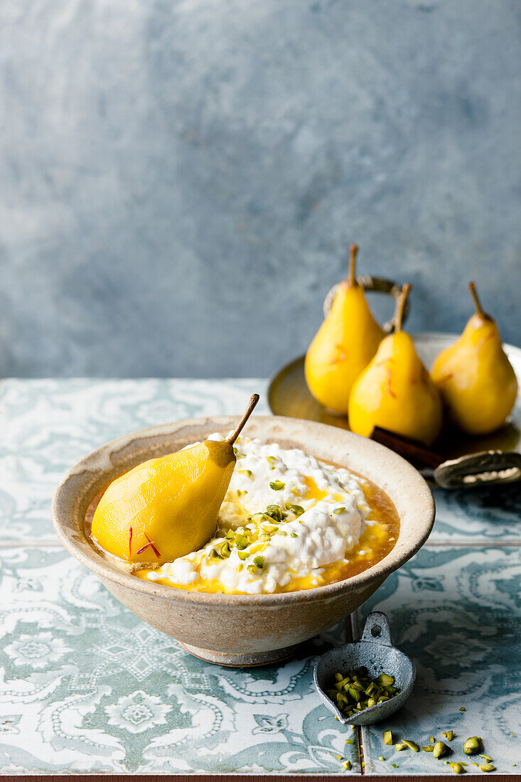 Spiced rice pudding with pistachios and saffron pears