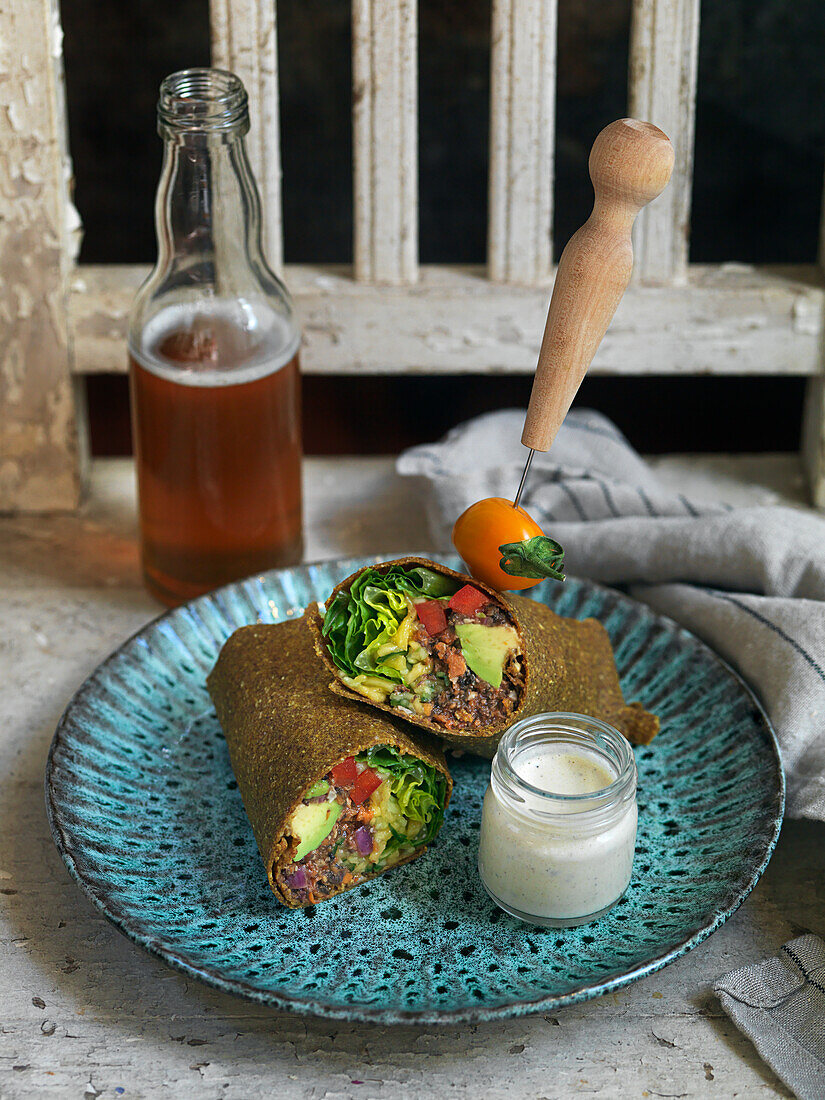 Roll filled with salad, avocado, greens, tomatoes