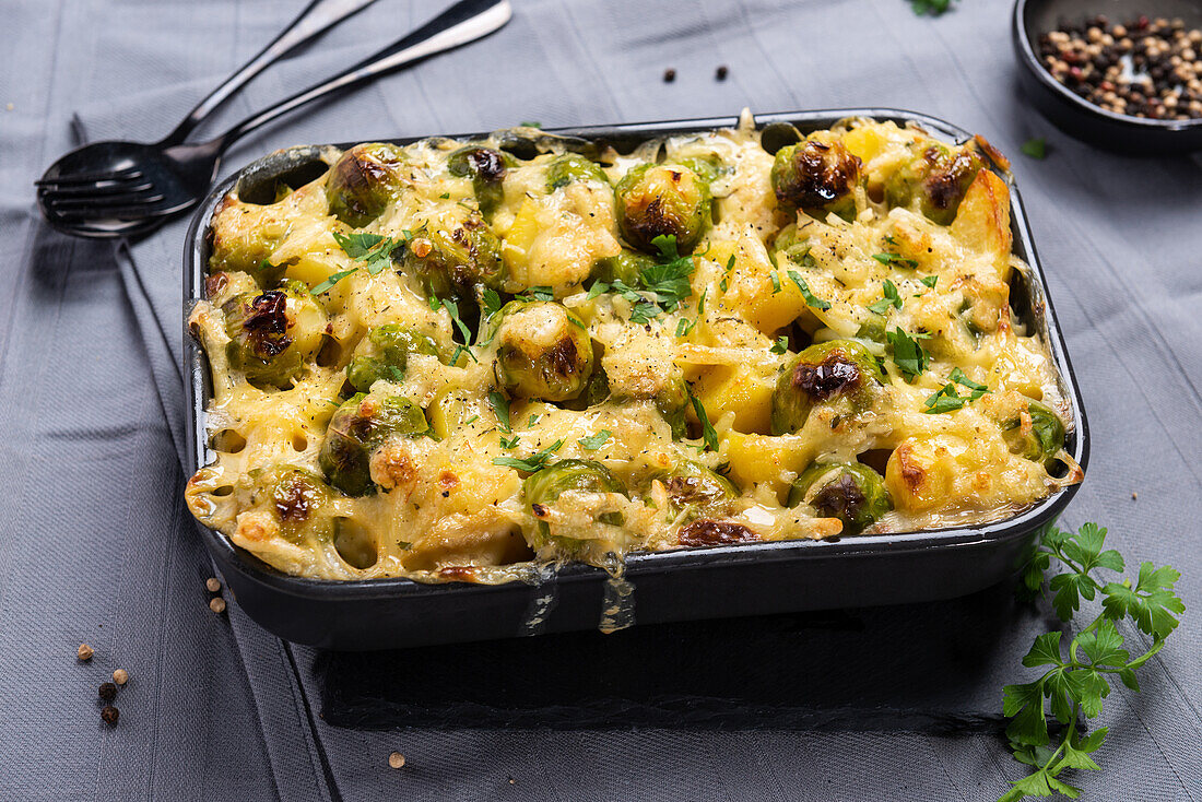 Vegan potato and Brussels sprouts bake, gratinated with almond cheese