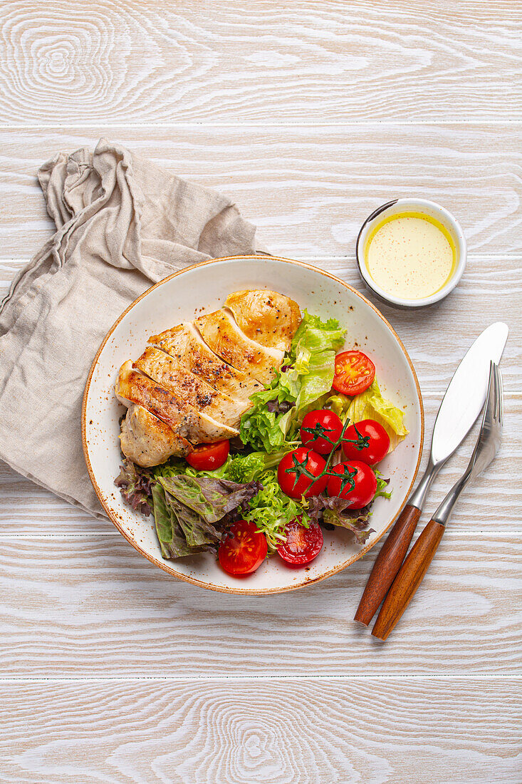 Healthy green vegetable salad with grilled chicken breast fillet