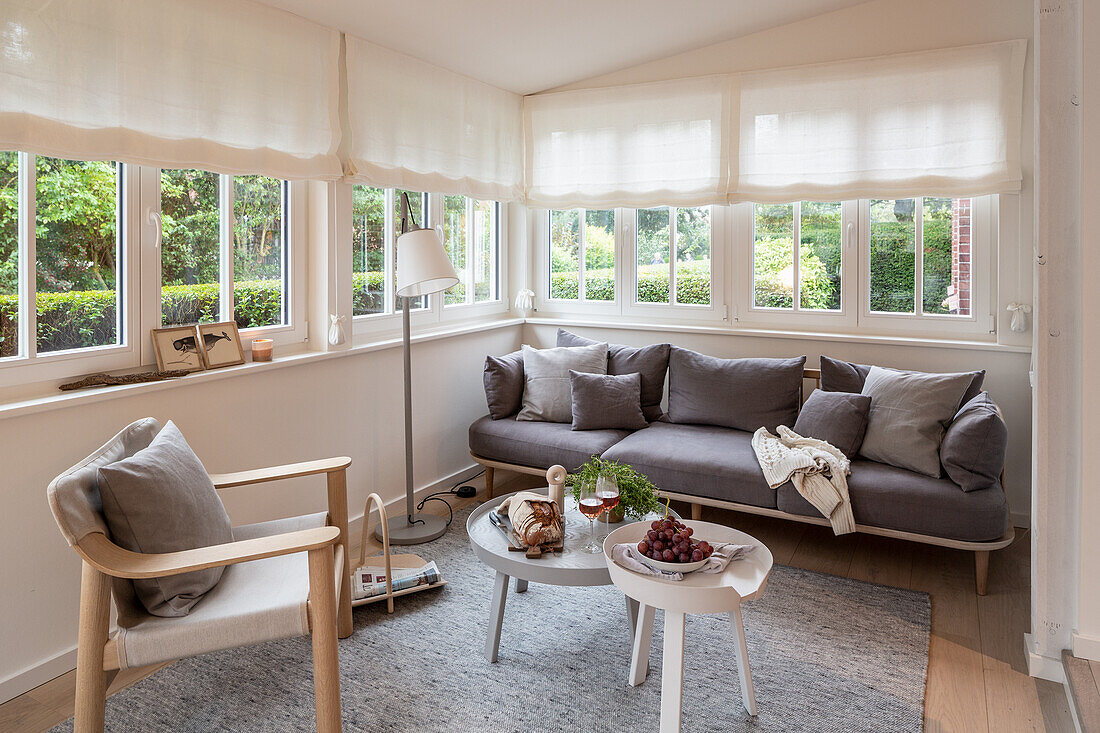 Scandinavian-style living room with wrap-around window strip