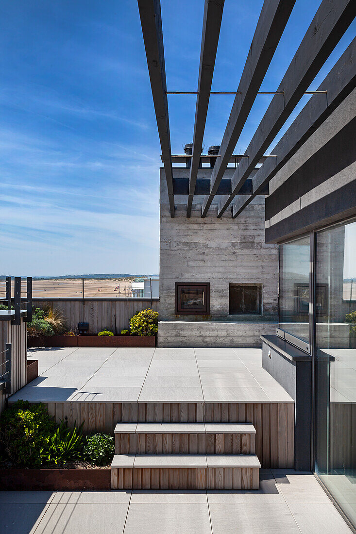 A terrace with steps to the next level against a blue sky