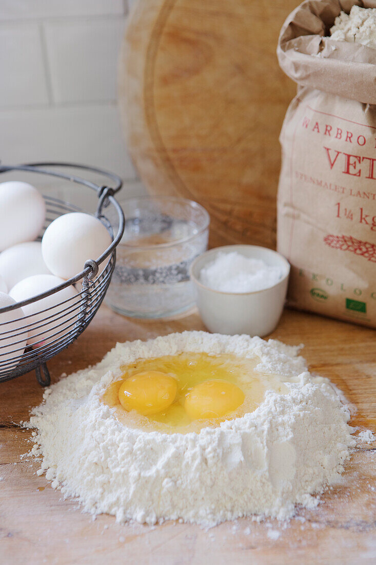Preparing to make the dough: eggs in flour trough